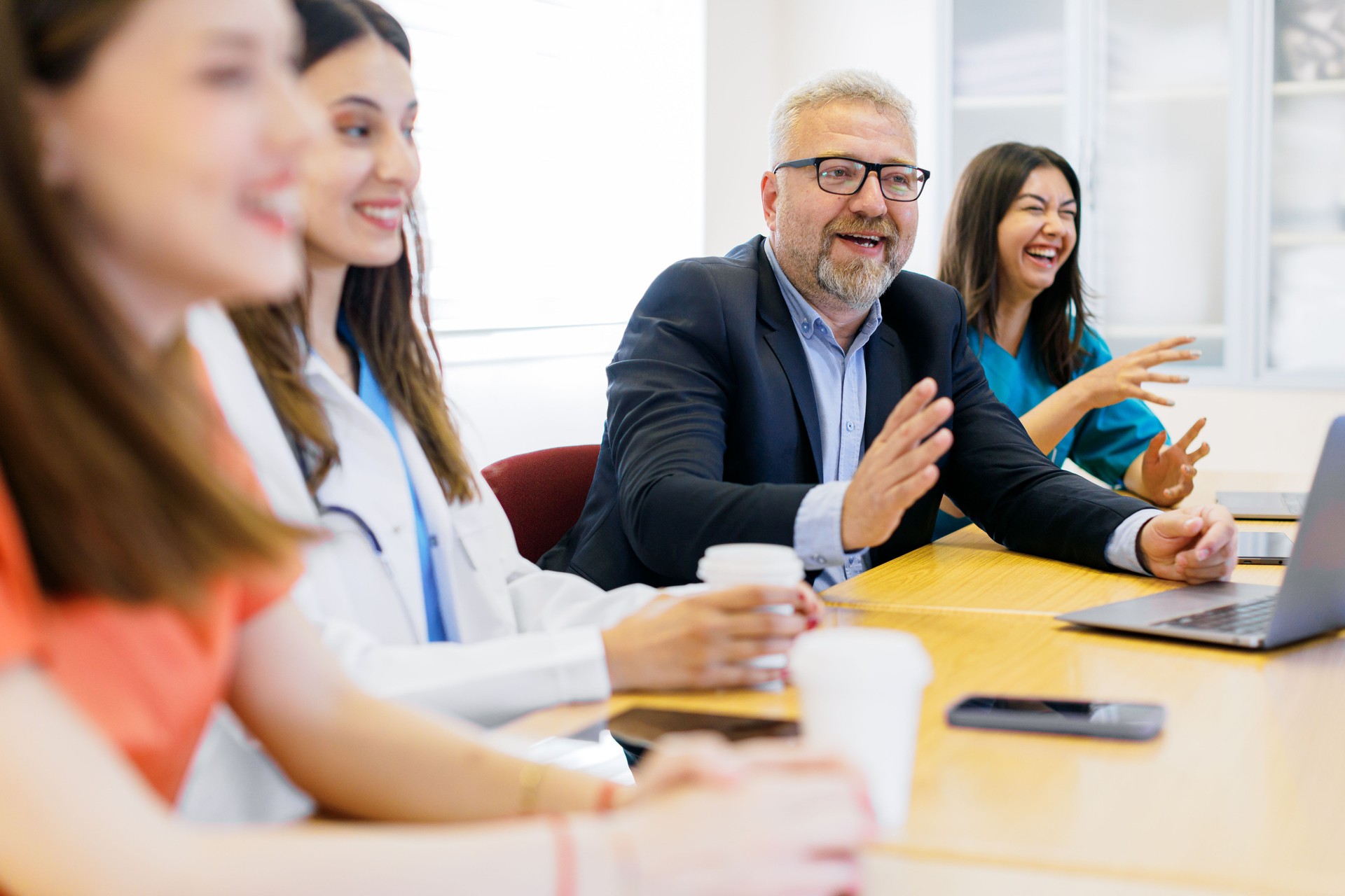 Collaborative Expertise: Group of Medical Team and Business People Meeting in Hospital and Office