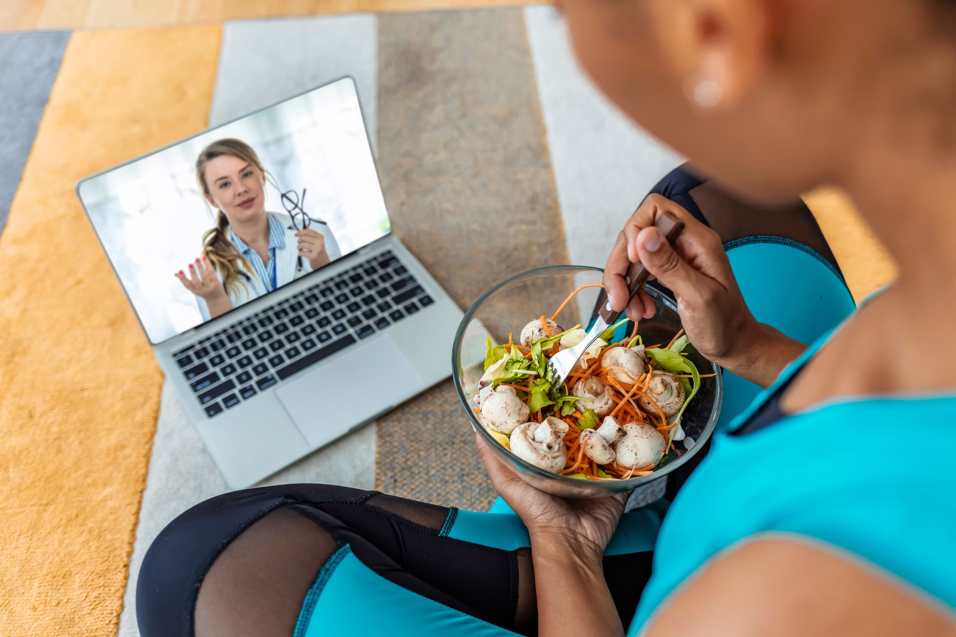 Unrecognizable woman talks with doctor during telemedicine visit
